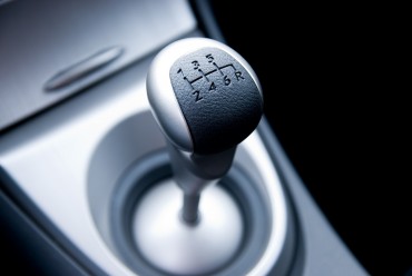 bigstock-Six-speed-gear-stick-in-a-bran-13192460.jpg