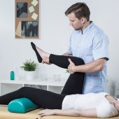bigstock-Male-Physiotherapist-Exercisin-97075748.jpg