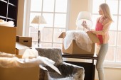 bigstock-Woman-removing-lamp-from-movin-92262560.jpg