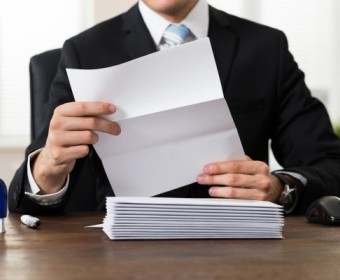 bigstock-Businessman-Holding-Document-A-100580345.jpg