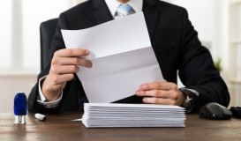 bigstock-Businessman-Holding-Document-A-100580345.jpg